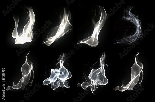 Set of isolated white wisp of curvy smoke on the black background