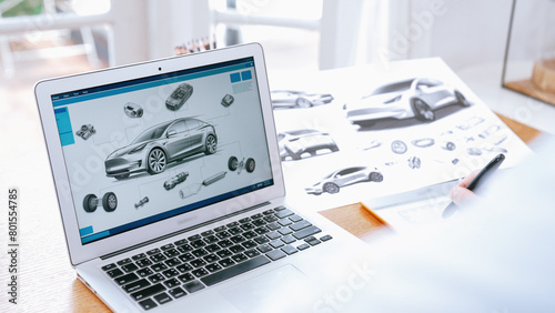 Car design engineer analyze car prototype for automobile business at home office. Automotive engineering designer carefully analyze, finding flaws and improvement for car design with laptop Synchronos