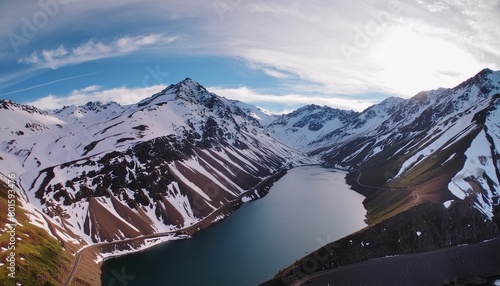 aerial panoramic view of the snowing mountains surrounding laguna del inca in the chilean andes chile