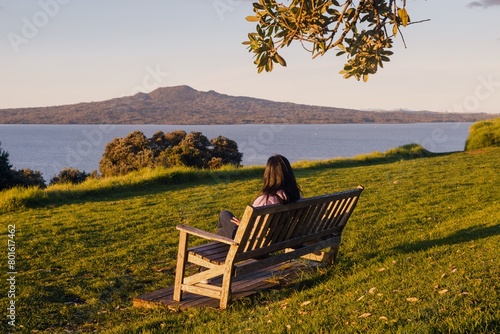 Park Bench on North head at sunset. Rangitoto Island is in the background. Devonport, Auckland, New Zealand.