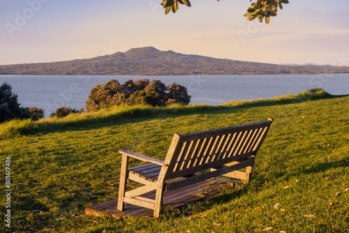 Park Bench on North head at sunset. Rangitoto Island is in the background. Devonport, Auckland, New Zealand.