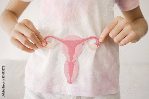 Preteen girl hands holding uterus, teen health, PCOS, first period concept