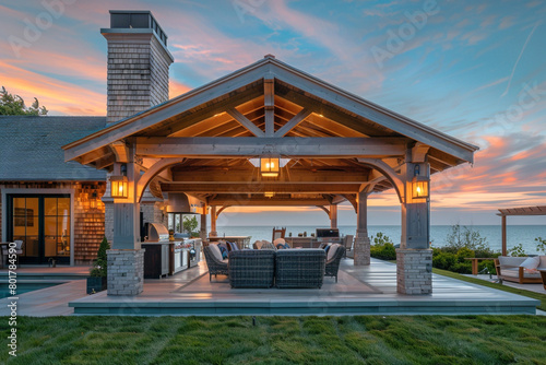 A seaside Craftsman villa with an open-air pavilion, outdoor kitchen, and direct access to a private beach, ideal for coastal living and entertaining.
