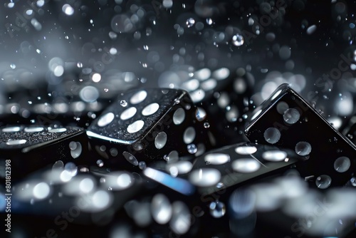 Floating Black Dice in Mid-Air with Water Droplets