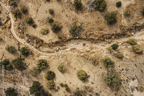 An aerial view of a dried-up riverbed after being washed away by the river, with a vast expanse of land.