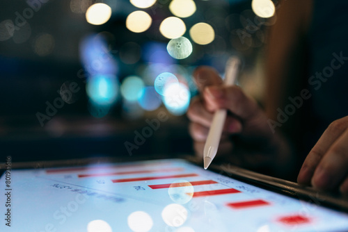 A businessman uses a digital tablet to view data