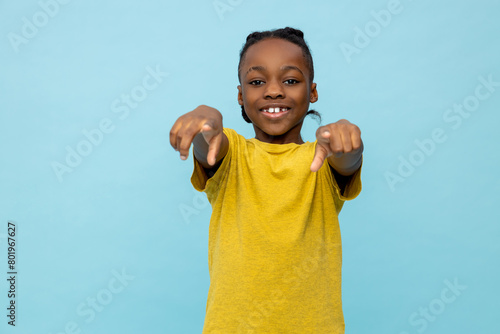Boy in yellow tshirt gesticulating and smiling