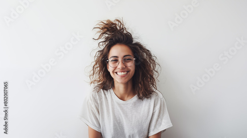 Beautiful dynamic young woman smiling and laughing on white plain background