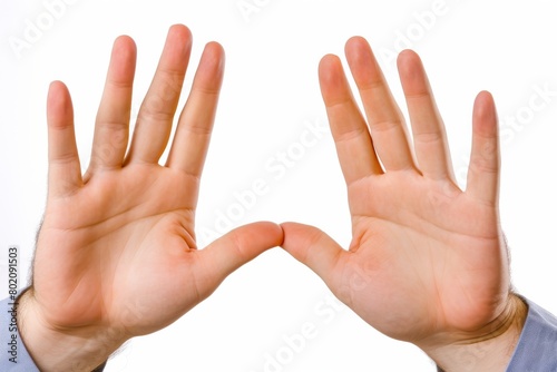Two hands are shown with fingers spread out, one hand is on top of the other