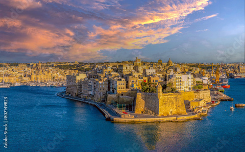 Dusk over the fortified sea front of Birgu (Cospicua), Grand Harbour, across from the old town of Valletta (Il-Belt), Malta