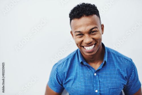 Happy, portrait and funny man laughing in studio with mockup, positive attitude and feel good mood or confidence on white background. Comic, face and African model smile for goofy joke or comedy