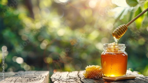 Glass jar with floral liquid honey with a piece of honeycomb on natural background and wooden table. Alternative sugar substitute, cold remedy and body strengthening, superfood, copy space
