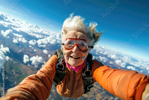 Happy mature woman senior woman taking selfie while sky diving. Extreme sport adventure for the second stage of life