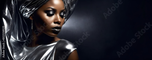 Black woman in a shimmering silver dress and turban, silver makeup with copy space