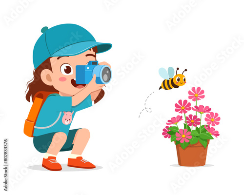 little kid holding camera and take photo of bee