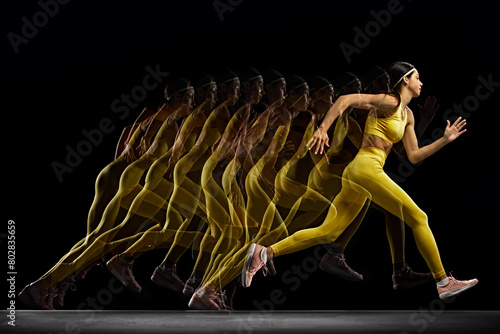 Dynamic image of young woman in yellow sportswear in motion, training, running against black background with stroboscope effect. Concept of sport, active and healthy lifestyle, game