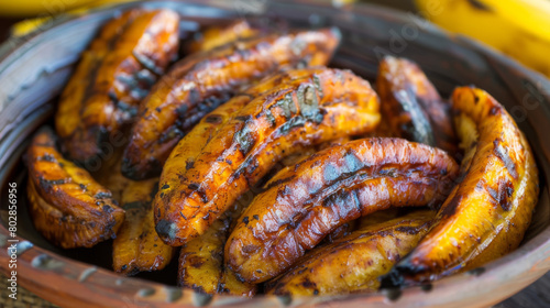 Grilled plantains, a traditional jamaican delicacy, served in a rustic woven basket with ripe bananas in the background - close-up view