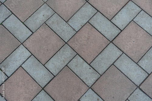 Backdrop - geometric pavement made of grey and brown concrete tiles