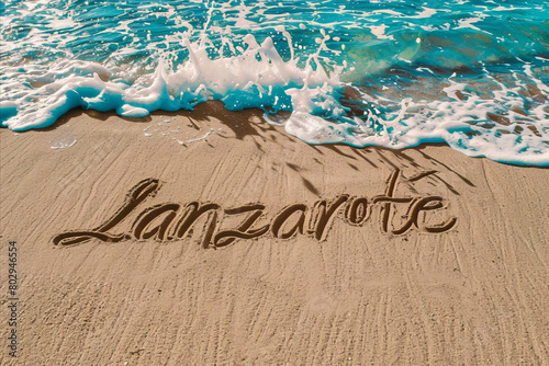 Lanzarote, Spain written in the sand on a beach. Spanish tourism and vacation background