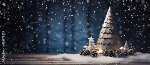 A Christmas cone adorned with ornaments sits on a dark wooden background while artificial snow completes the scene Copy space image
