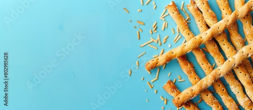 Breadsticks or Salted crackers on a Blue background with Space for adding text on top.