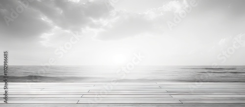 A black and white image of a wooden pier boardwalk provides a stunning contrast against the backdrop of the sea creating a beautiful seasonal natural background. with copy space image