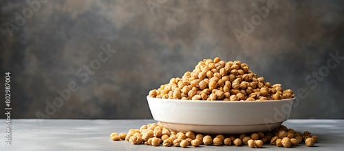 A copy space image featuring a bowl of raw organic chickpeas beans on a gray stone background