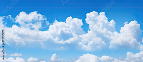 A background image featuring a clear blue sky adorned with fluffy white clouds Copy space available