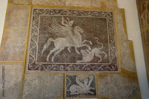 Rhodes, Greece - August 10, 2017: Mosaic depicting a rider fighting a lion at the Archaeological Museum on the island of Rhodes, Greece.