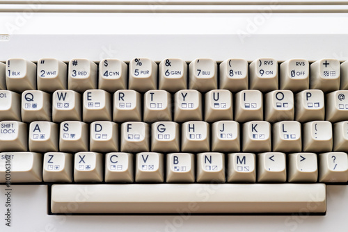 Close-up of vintage Commodore 64 keyboard with cream-colored keys and letters. Daylight illuminating the retro computer.