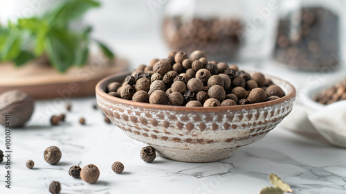 Bowl with allspice on white table