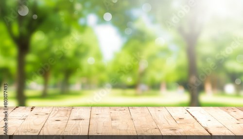 Nature background, Wood table for food and product display over blur green tree garden, Blur park nature outdoor and wood table with bokeh light background in spring and summer