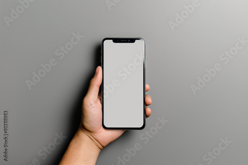 Hand holding a mobile phone with a blank screen, a portable communication device. Mockup. Generative AI