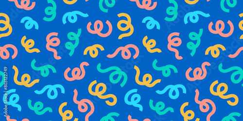 Colorful party streamer swirls and squiggle doodles pattern on blue for fun birthday invites and festive backgrounds.