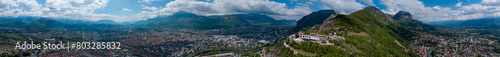 Aerial view of Grenoble's Bastille fort, city skyline crossed by the river and surrounded by mountains. France