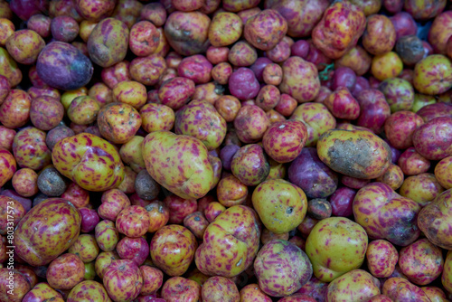 Close-up of many Olluco (Ullucus tuberosus), a tuber from the Andes mountains of South America. Known as melloco or papa lisa
