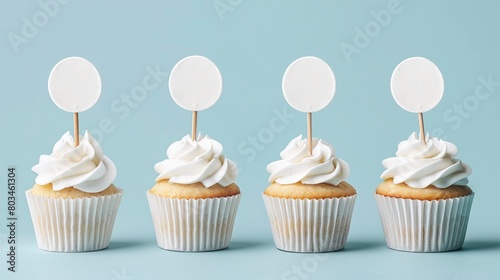 Beautiful simple white cupcakes topped with a paper circle tag stick. Perfect cupcakes with white icing for product mockup.