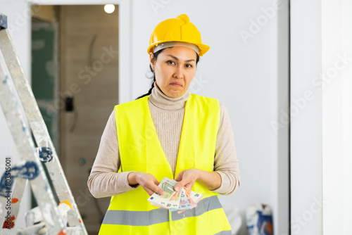 Frustrated deceived woman builder is unhappy with earned money