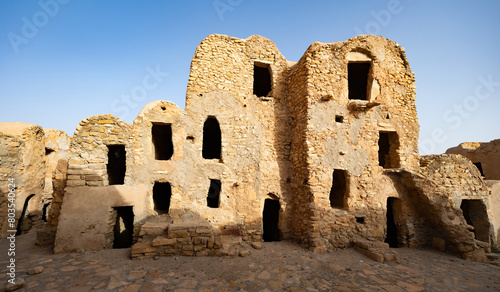 Ruins of ancient abandoned Berber granary structures in Ksar Daghar in Tunisia, standing as testament to traditional North African architecture