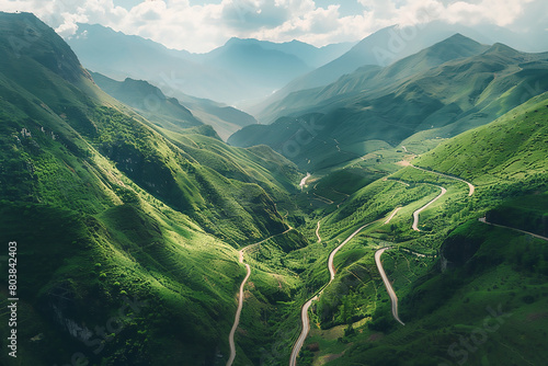 Aerial view of a winding mountain road in Yunnan, China with green mountains and rivers on a sunny day. The photography has a high resolution and was taken with a Canon EOS camera using a wide-angle l