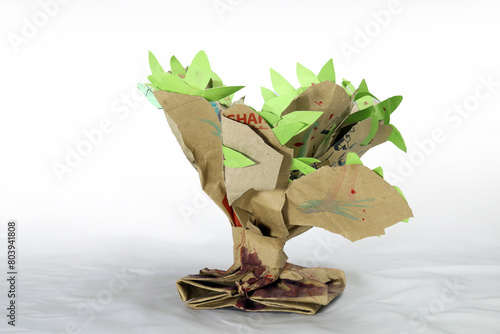 A paper tree hand craft made for student's school project. Paper recycling creative idea. just twisting and shaping a paper bag and adding few leaves on it.