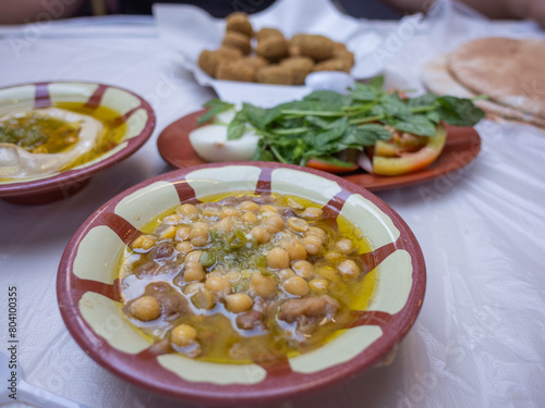 traditional arabic breakfast; hummus, falafel, foul, etc. on the table of the restaurant in capital amman