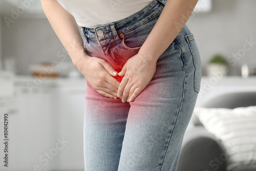 Woman suffering from cystitis symptoms indoors, closeup