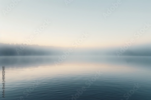 The smooth surface of a lake at dawn, undisturbed
