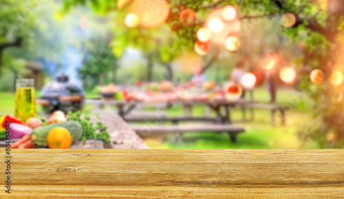 summer time party in backyard garden with grill BBQ and vegetables, wooden table, blurred background