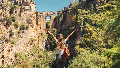 Happy female tourist enjoying view of famous bridge in touristic village of Ronda in Spain- Province of Malaga