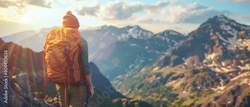 Girl standing on a mountain peak watching the sunset