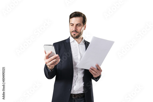 A businessman holding documents and a smartphone on a white background, depicting multitasking