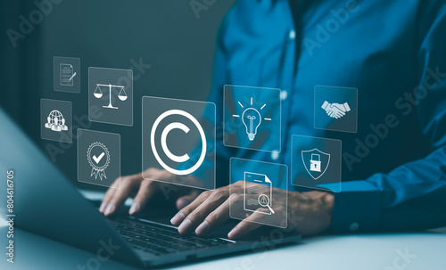 Copyright or patent concept. Professional working on a laptop with digital icons representing intellectual property and digital copyright law. Trademark license, copyleft, Rights symbol, Piracy crime,