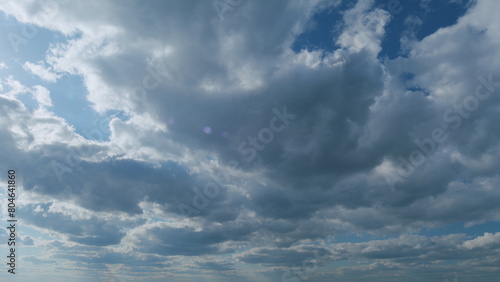 White stratocumulus and stratus cloudscape on beautiful sunny clear sky. Tropical summer sunlight. Timelapse.